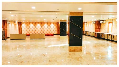 a large lobby with chairs and a table at Hotel Ru-pam Tower Patna AC or Non Ac Room in Patna