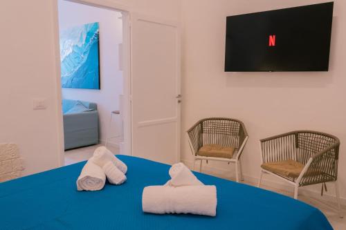 a room with two towels on a blue table at Rosalù - Sea View in Polignano a Mare