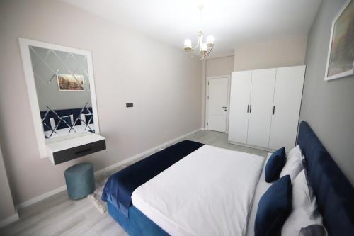 a bedroom with a large bed and a mirror at Prime Boutique Hotel in Baku