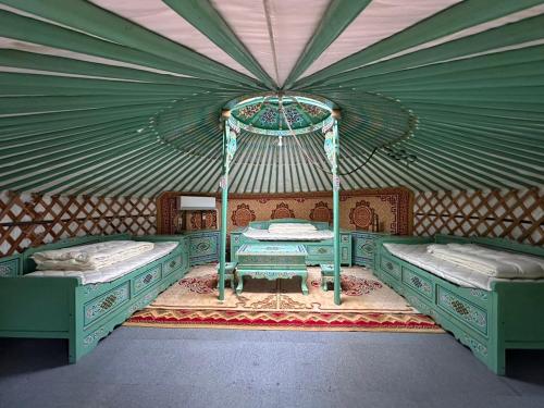 a bedroom with two beds in a tent at モンゴリアンテーマパークジャパン in Kamigō