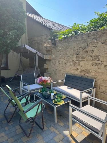two chairs and a table and chairs on a patio at Дом для отдыха на Фонтане in Odesa