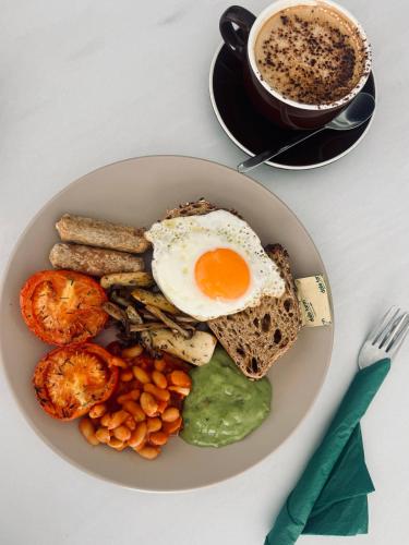 a plate of food with an egg and toast and a cup of coffee at Unit 3 Sleek 1-BR Stays, Near Sheffield United Football Club, Fast Wi-Fi, Parking in Sheffield