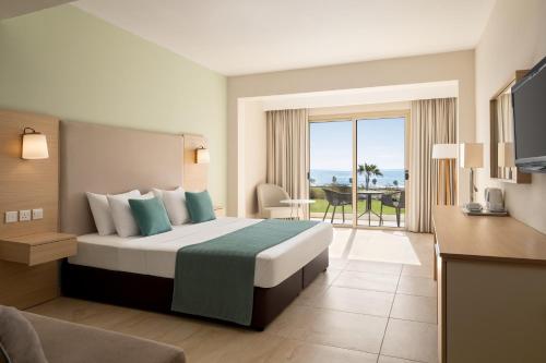a hotel room with a bed and a balcony at Freij Hotel & Resort in Ayia Napa