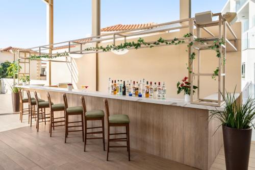 a row of stools at a bar in a building at Freij Hotel & Resort in Ayia Napa