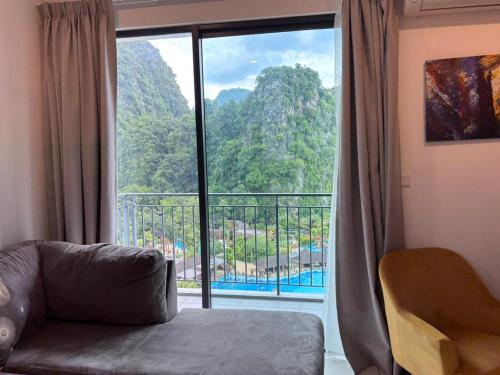 a living room with a large window with a view at Theme Park Ipoh - Onsen Premier Suites By MICASA GROUP in Ipoh