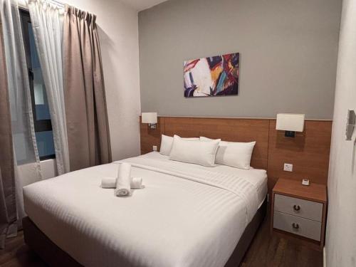 a bedroom with a bed with a teddy bear on it at Theme Park Ipoh - Onsen Premier Suites By MICASA GROUP in Ipoh