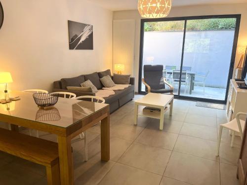 a living room with a couch and a table at Chalet du Parc in Ax-les-Thermes
