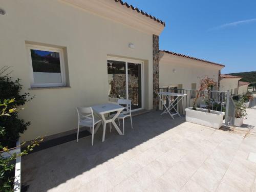 a patio of a house with a table and chairs at Hotel Borgo Dell'Orso in Palau