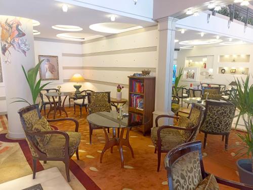 a restaurant with tables and chairs in a room at OTEL KÂYA in Izmir