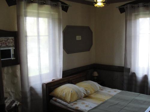 a bedroom with a bed with two pillows on it at Pokoje i domki Saraceńska Chata in Stegna