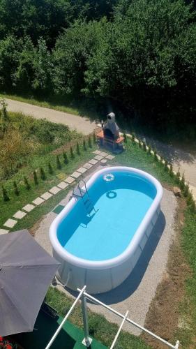 a swimming pool in a yard with an umbrella at Cosy home D&D in Brod Moravice