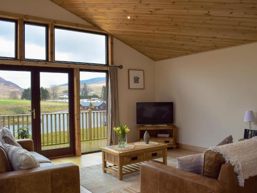 a living room with a couch and a television at Frith View in White Bridge
