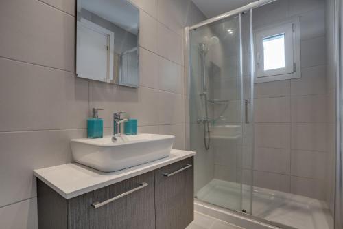a bathroom with a sink and a shower at Majestic Sunset Salt Lake Views 300m From Beach in Larnaka
