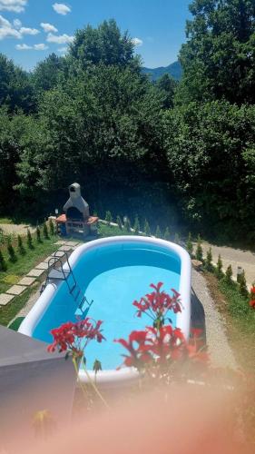 a car driving down a road with a person sitting on a bench at Cosy home D&D in Brod Moravice