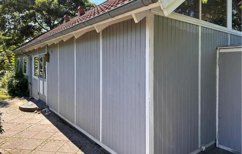 a white building with a garage at Holiday Home Jacobslystvej Gilleleje Xi in Gilleleje