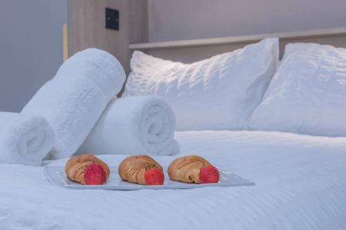 three strawberries on a plate on a bed at Unit 1 Bright & Classy 1-BDR Flat, Fast Wi-Fi, Free Parking, Intimate Location in Sheffield