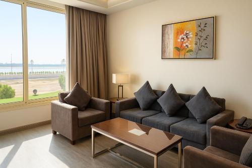 a living room with a couch and a table at Elite Served Apartments - Al Cornich in Jeddah
