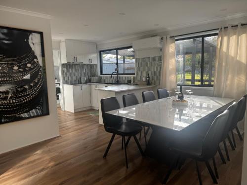 a dining room and kitchen with a table and chairs at 3 Bedrooms, Steps to the Shore in Rye
