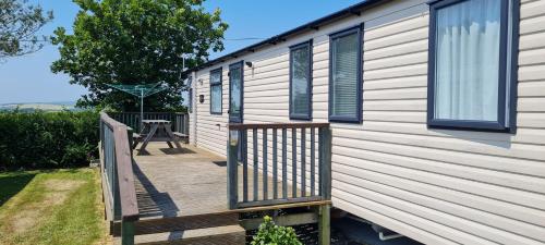 a wooden deck on the side of a house at Polborder Holidays Looe Country Park in Looe