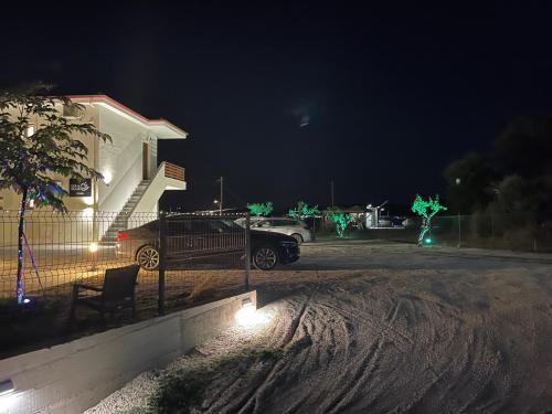 a car parked in front of a house at night at seaandolive in Ammouliani