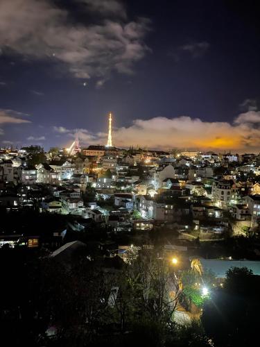 a city lit up at night with the eiffel tower at LENA Home in Da Lat