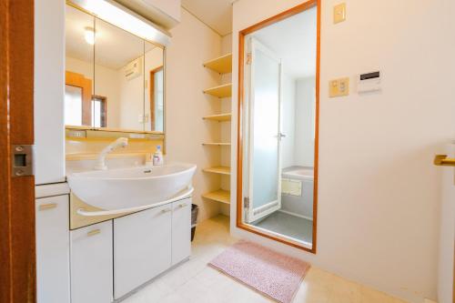 a bathroom with a sink and a mirror at Three minutes walk to subway Direct to the airport Umeda business district in Osaka