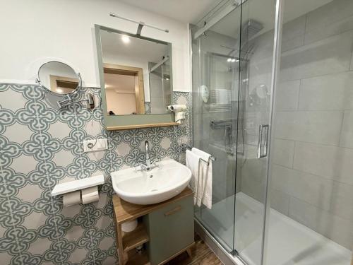 a bathroom with a sink and a shower at Apartment am Tannenweg in Badenweiler