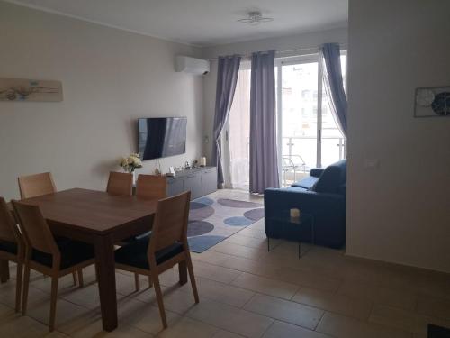 a living room with a table and a blue couch at Boavista Estoril Residence Sol & Mar in Sal Rei