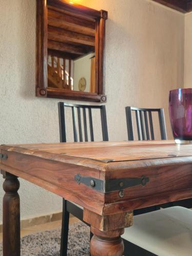 a wooden table with a wine glass and a mirror at Livadi Hideway Chalet by Ski Alure in Arachova