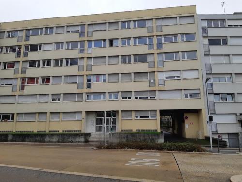 a large apartment building with a parking lot in front of it at Gabcha in Metz