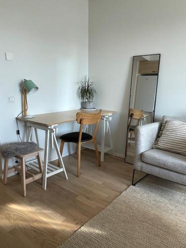 a living room with a table and a chair and a couch at Studio apartment in Kuusamo in Kuusamo