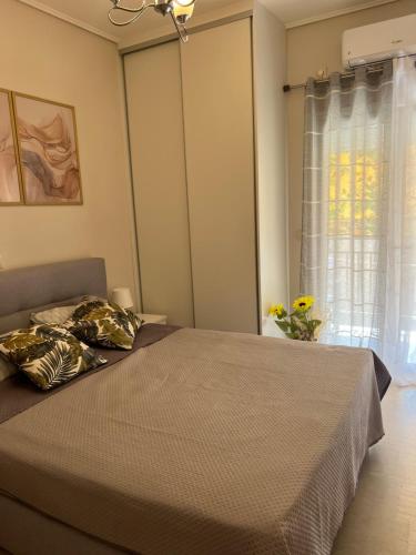 a bedroom with a bed and a window at Sea and Cinema in Loutraki