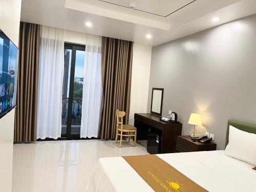 a hotel room with a bed and a desk at Sunrise Airport Hotel - Noi Bai Airport in Thach Loi