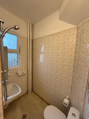 a bathroom with a toilet and a tub and a sink at NDK NEST 2BR Apartment in the Heart of Sofia in Sofia