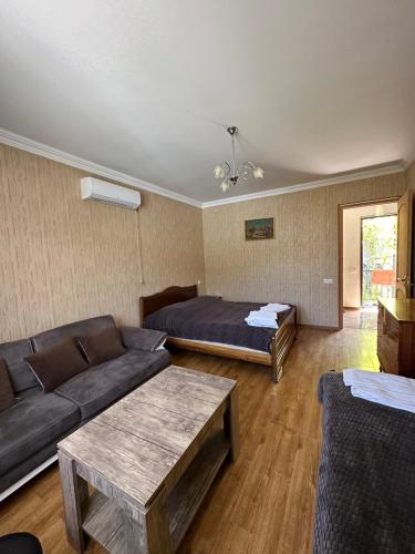 a living room with a couch and a bed at zeiko s guesthouse in Borjomi