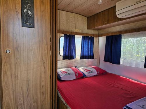 a small bed in the back of a rv at Camping Little Oasis in Ezerets