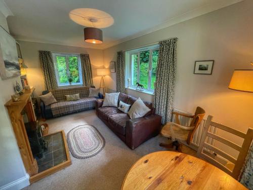 a living room with a couch and a table at Cherryford House in Gidleigh