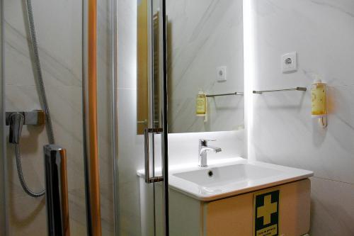 a bathroom with a sink and a shower at Apartamentos Avenida Premium in Vila Real
