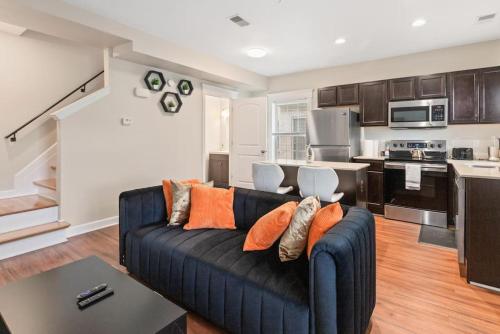 a living room with a blue couch and a kitchen at Stylish & Cozy 1-BR Detroit in Detroit