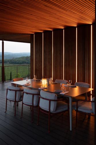 une salle à manger avec des tables et des chaises sur une terrasse dans l'établissement Le Prieuré - Château La Martinette, au Thoronet