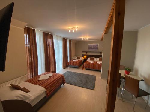 a hotel room with two beds and a balcony at Eurybia in Łeba