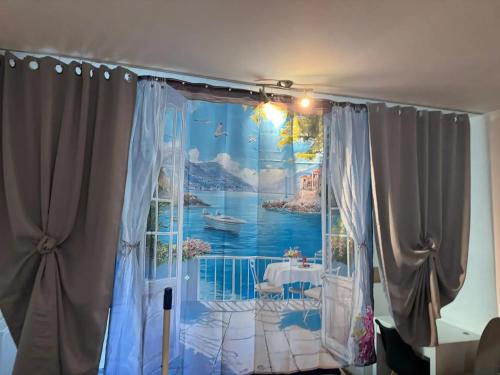 a room with a window with a painting of a balcony at Comfortable studio in Bevaix with mountain view - 30 m² + Spa in Bevaix