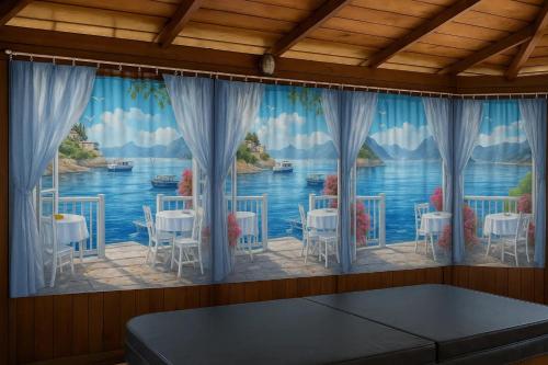 a large window with a view of the water at Comfortable studio in Bevaix with mountain view - 30 m² + Spa in Bevaix