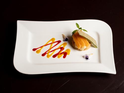 a white plate with a dessert on a table at 小樽旅亭 蔵群 in Otaru