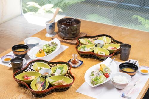 a table with four dishes of food on it at 小樽旅亭 蔵群 in Otaru