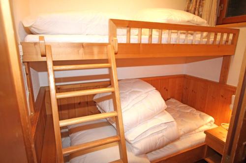 two bunk beds in a room with a ladder at Ferienwohnung Königsleiten 251 - Top EG in Königsleiten