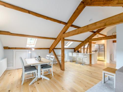 a kitchen and dining room with wooden beams at Cragdale Penthouse in Settle