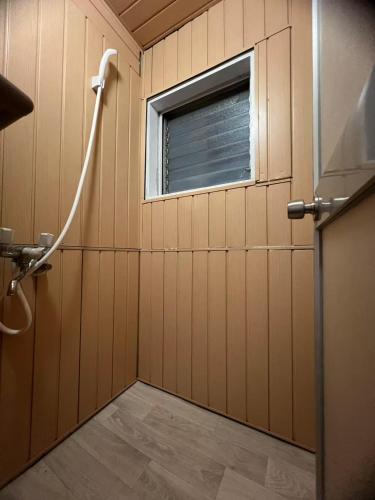 a bathroom with a shower and a window at 和風2西北口 in Tokyo