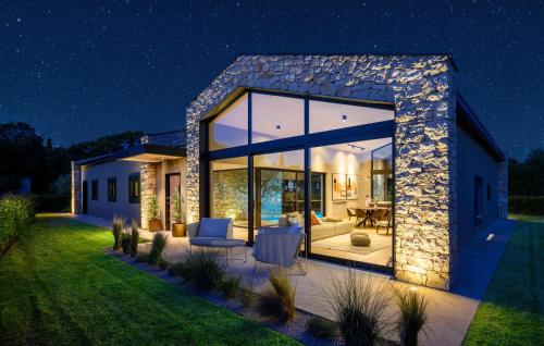 a house with a stone facade at night at Villa Silente in Bale