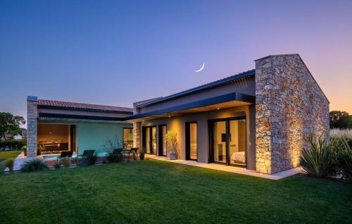 a house with a lawn in front of it at Villa Silente in Bale